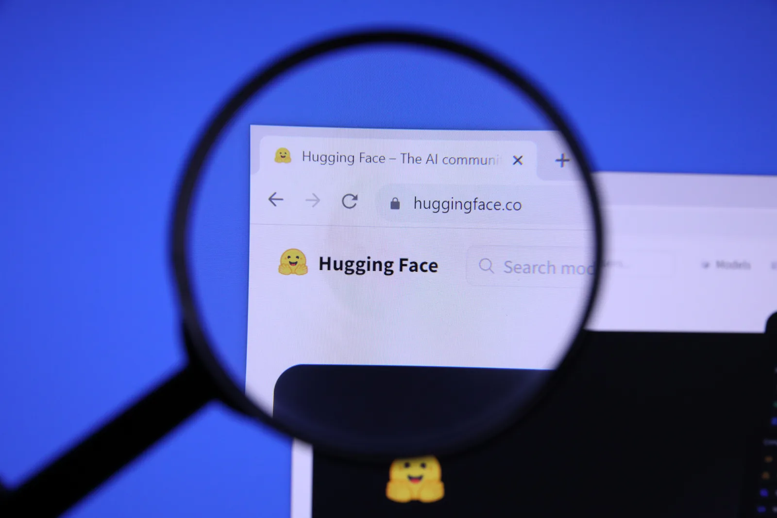 The Hugging Face website viewed through a magnifying glass.