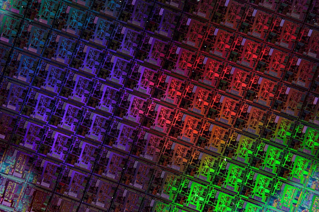 Close-up view of a semiconductor wafer, representing custom AI chips and the hardware race behind frontier AI systems.